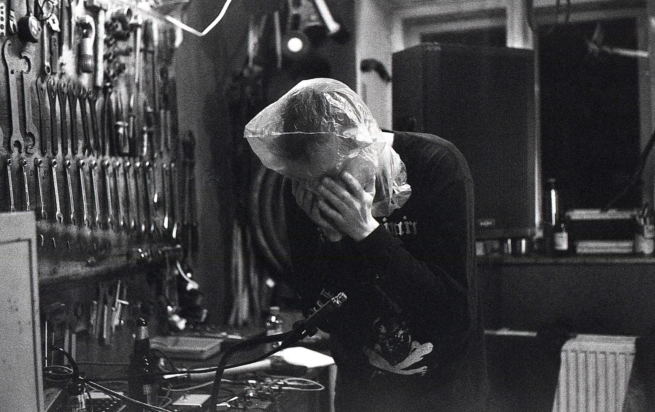 Max Wainwright during a performance. I'm wearing a plastic bag on my head and grabbing it to make sounds (picked up by a microphone). Photo by Martin-Šenkypl